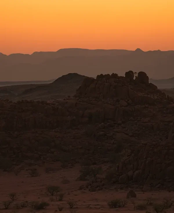 Dramatic sunset over rocky desert landscape and mountains in Damaraland, Namibia Dramatic sunset over rocky desert landscape and mountains in Damaraland, Namibia